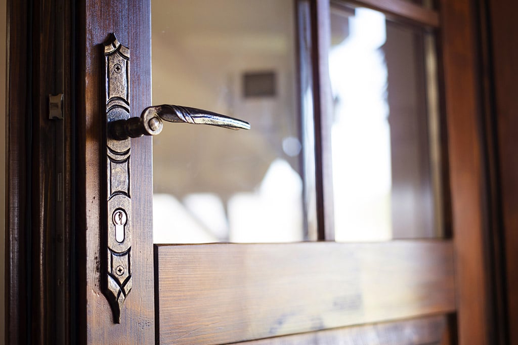 Detail of an old engraved door handle, exterior door installation