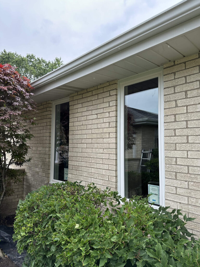 A beautiful brick house featuring newly installed energy-efficient windows and well-maintained landscaping in the Chicago suburbs.