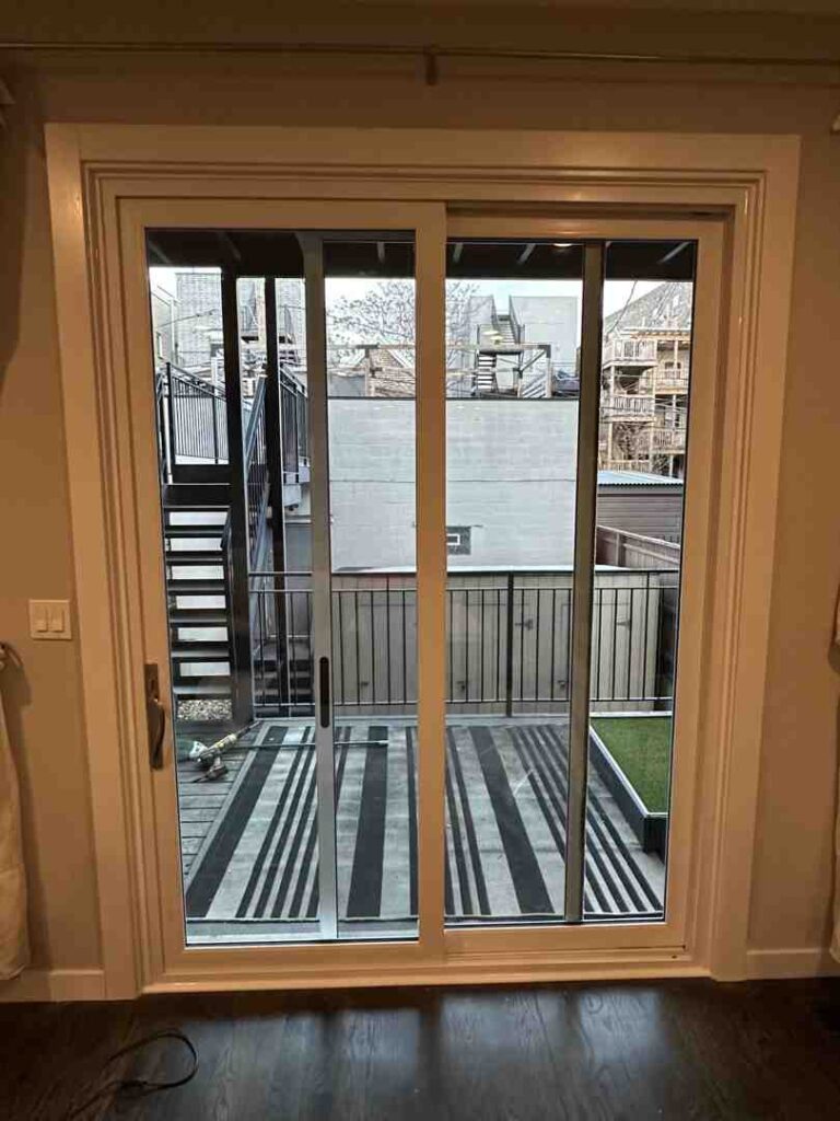 sliding glass door opening to backyard patio