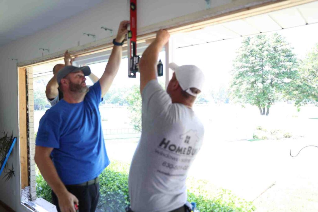 Window installer examining frame integrity