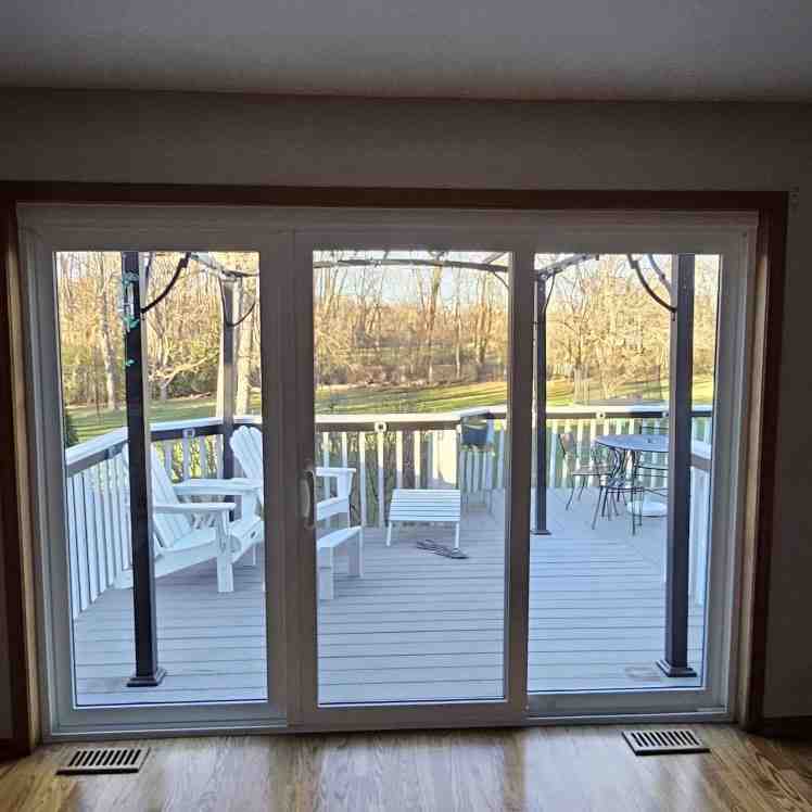 Sliding glass patio door opening onto a backyard